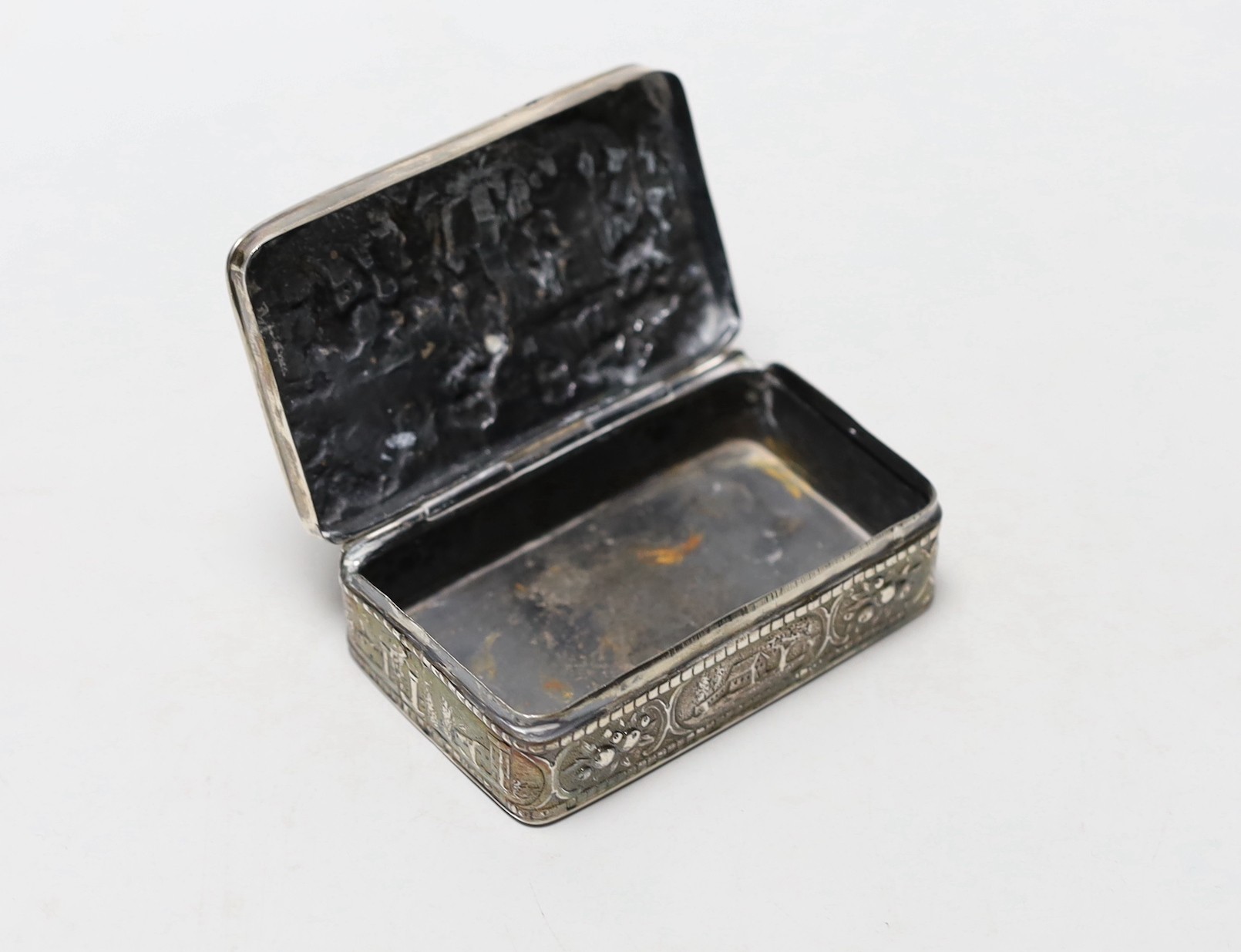 An early 20th century Hanau silver rectangular box, embossed with revellers, import marks for Sheffield, 1900, 87mm.